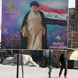 A poster of Shiite cleric Muqtada Al-Sadr in Sadr City in Baghdad, on Oct. 17, 2021. (Photo via Getty Images)