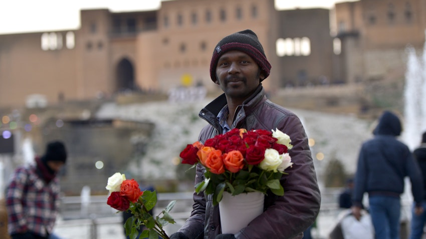 A Bangladeshi man sells roses in Erbil, Iraq on Jan. 30, 2022. (Photo via Getty Images)