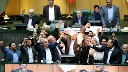  Iranian lawmakers setting fire to a copy of the 2015 nuclear deal in Tehran on May 9, 2018. (Photo via Mizan)