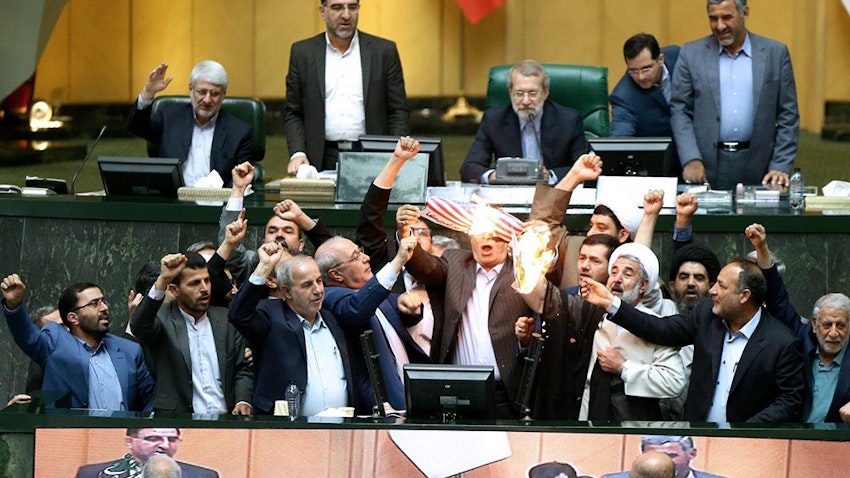  Iranian lawmakers setting fire to a copy of the 2015 nuclear deal in Tehran on May 9, 2018. (Photo via Mizan)