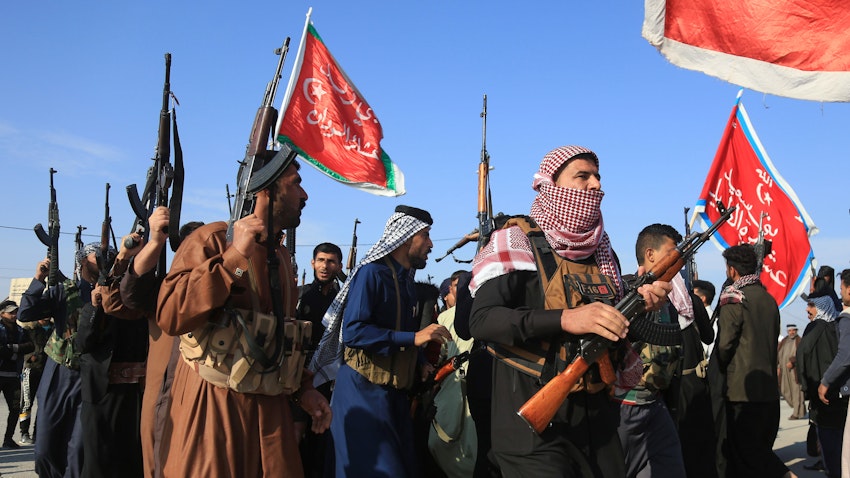 Armed clan members take to the streets in a show of power amidst anti-government protests in Karbala, Iraq on Dec. 8, 2019. (Photo via Getty Images)