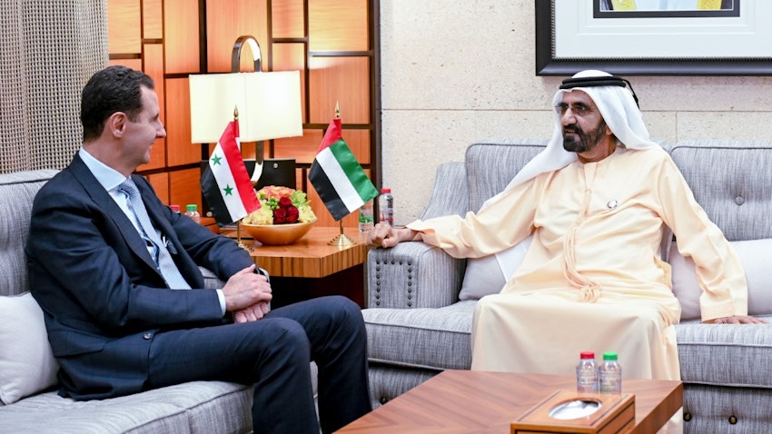 Syrian President Bashar Al-Assad (L) sits with Dubai's ruler Mohammed bin Rashid Al Maktoum on Mar. 18, 2022. (Handout photo via WAM)