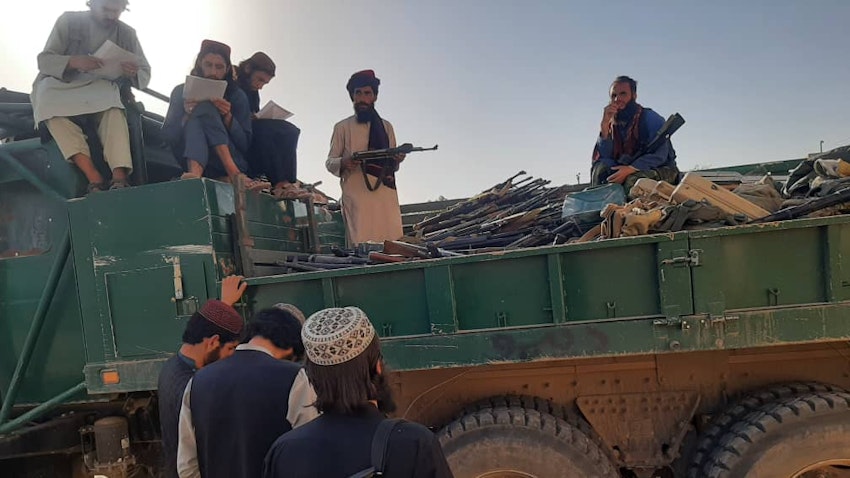 Taliban fighters receive military equipment belonging to the former Afghan government from Iran on June 8, 2022. (Source: QaharBalkhi/Twitter)