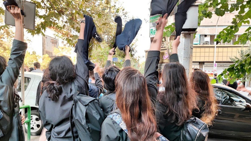 A group of female students remove their hijabs during protests in Iran on Oct. 1, 2022. (Photo via social media)