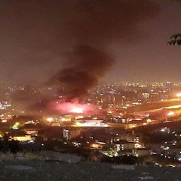 A hilltop view of Evin Prison on fire in northern Tehran, Iran on Oct. 15, 2022. (Photo via social media)