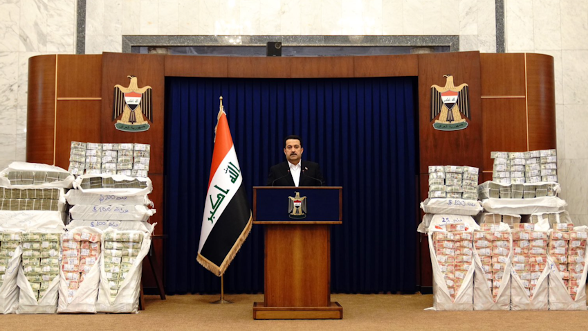 Iraqi Prime Minister Muhammad Shia Al-Sudani pictured with stacks of recovered state funds in Baghdad, Iraq on Nov. 27, 2022. (Source: IraqiPMO/Twitter)