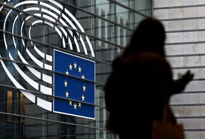 A woman walks near the entrance of the European Parliament in Brussels, Belgium on Dec. 9, 2022. (Photo via Getty Images)