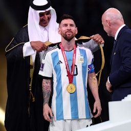 Lionel Messi of Argentina presented with traditional Arab cloak after winning FIFA World Cup Qatar Final match in Lusail City, Qatar on Dec. 18, 2022. (Photo via Getty Images)