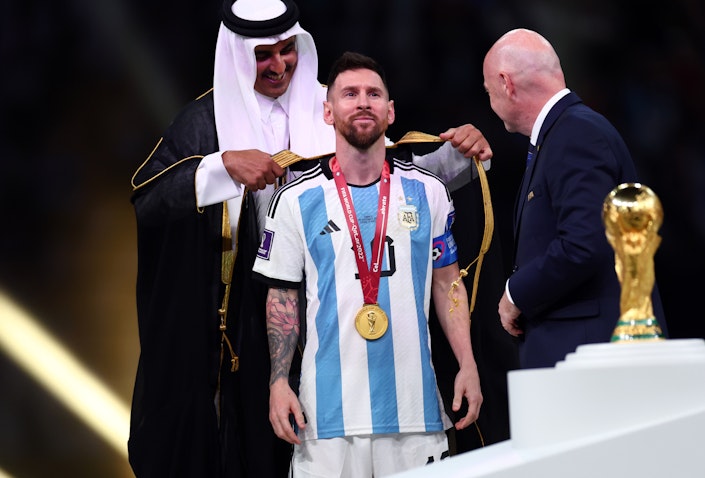 Lionel Messi of Argentina presented with traditional Arab cloak after winning FIFA World Cup Qatar Final match in Lusail City, Qatar on Dec. 18, 2022. (Photo via Getty Images)