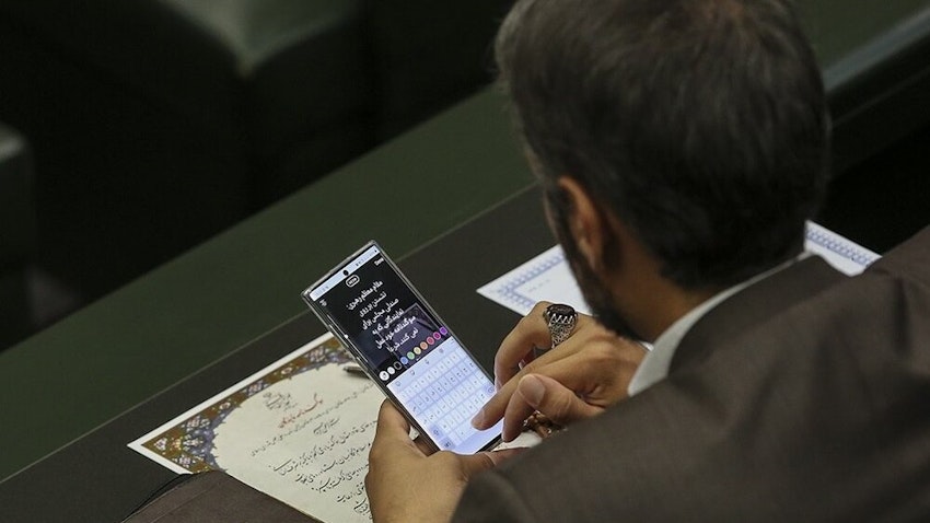 A lawmaker drafts an Instagram Story in the Iranian parliament in Tehran, Iran on May 27, 2020. (Photo via Fars News Agency)