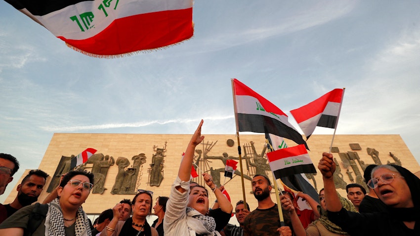 Demonstrators wave Iraqi flags in Tahrir Square in Baghdad, Iraq on Oct. 25, 2022. (Photo via Getty Images)