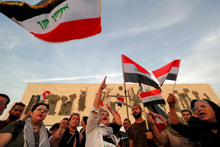 Demonstrators wave Iraqi flags in Tahrir Square in Baghdad, Iraq on Oct. 25, 2022. (Photo via Getty Images)
