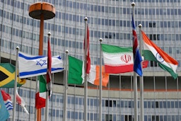 The Iranian flag flies among several others outside of the IAEA's headquarters in Vienna, Austria on May 23, 2021. (Photo via Getty Images)