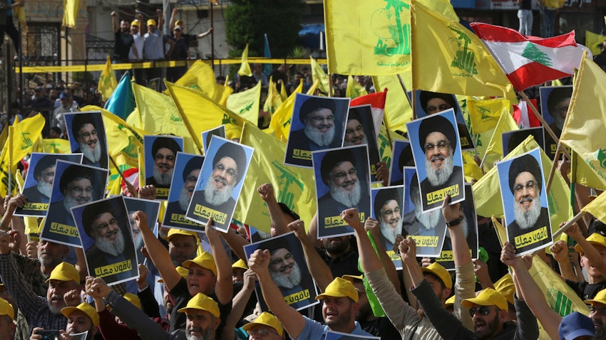 Supportes of the Lebanese Shiite movement Hezbollah raise images of the group's leader Hassan Nasrallah in Nabatiyeh, Lebanon on May 9, 2022. (Photo via Getty Images)