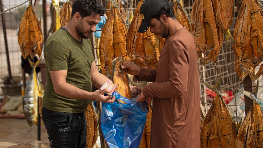 A vendor sells dried fish in the southern city of Basra, Iraq on Apr. 29, 2022. (Photo via Getty Images)