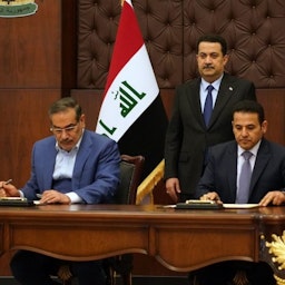 Iraqi Prime Minister Muhammad Shia’ Al-Sudani, Iraqi National Security Advisor Qasim Al-Araji and Iran’s SNSC Secretary Ali Shamkhani sign a security agreement in Baghdad, Iraq on Mar. 19, 2023. (Photo via Iraqi News Agency)
