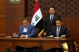 Iraqi Prime Minister Muhammad Shia’ Al-Sudani, Iraqi National Security Advisor Qasim Al-Araji and Iran’s SNSC Secretary Ali Shamkhani sign a security agreement in Baghdad, Iraq on Mar. 19, 2023. (Photo via Iraqi News Agency)