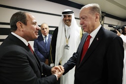 Turkish President Recep Tayyip Erdogan shakes hands with President of Egypt Abdel Fattah el-Sisi in Doha, Qatar on Nov. 20, 2022. (Photo via Getty Images)