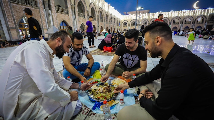 عراقيون يتناولون وجبة إفطار رمضانية في مسجد الشيخ عبد القادر الجيلاني في بغداد، العراق يوم 30 مارس/آذار 2023. (الصورة عبر غيتي إيماجز)