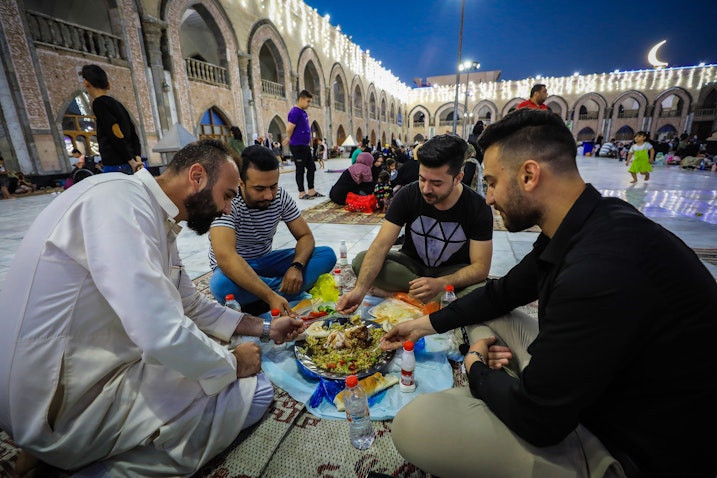 Iraqis break their fast during the holy month of Ramadhan, at Abdul-Qadir Gilani Complex in Baghdad, Iraq on Mar. 30, 2023. (Photo via Getty Images)