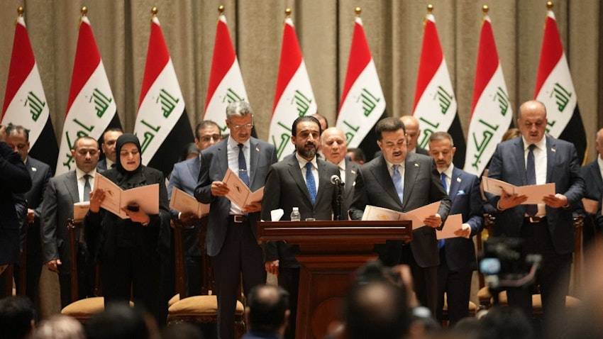 Iraq's Prime Minister Muhammad Shia’ Al-Sudani and Parliament Speaker Mohammed Al-Halbousi pictured as ministers take the oath in Baghdad, Iraq on Oct. 27, 2022. (Photo via Getty Images)