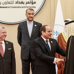 Jordan’s King and Iran’s foreign minister look on as Egypt's president shakes hands with a dignitary at the Baghdad Conference in Sweimeh, Jordan on Dec., 20, 2022. (Photo via Getty Images)