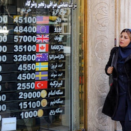 Currency rates displayed at an exchange office in Tehran, Iran on Feb. 22, 2023. (Photo via Getty Images)