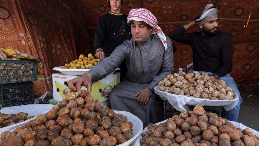 A merchant sells desert truffles at the central market in Samawa, Iraq on Mar. 1, 2023.  (Photo via Getty Images)