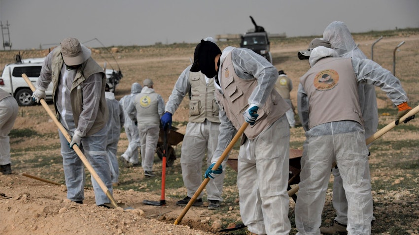 A UNITAD investigative team excavates a mass grave site in Hamadan near Sinjar, Iraq on Mar. 28, 2023. (Photo via UNITAD)