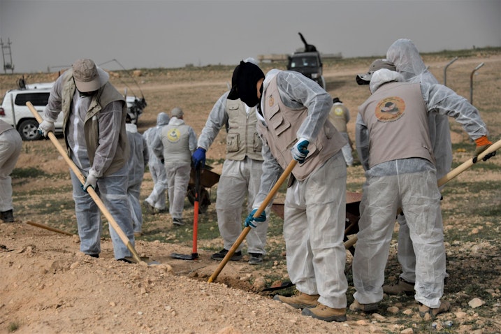 A UNITAD investigative team excavates a mass grave site in Hamadan near Sinjar, Iraq on Mar. 28, 2023. (Photo via UNITAD)