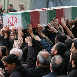 Coffins bearing the bodies of Iranian fighters recently identified and returned from Syria are carried during a funeral procession in Tehran, Iran on Dec. 2, 2023. (Photo via Tasnim News Agency)