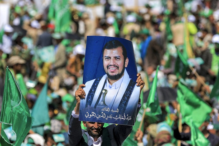 A Yemeni man lifts a portrait of Houthi leader Abdul Malik Al-Houthi in Sana'a, Yemen on Sept. 27, 2023. (Photo via Getty Images)