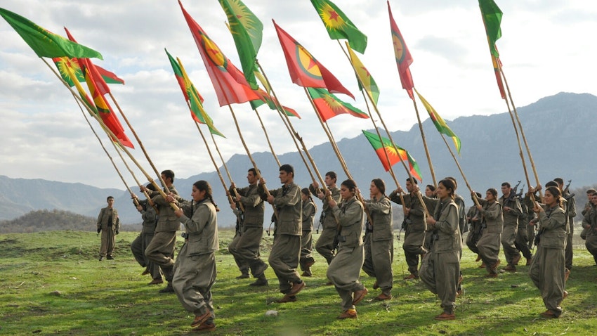 Kurdish militants belonging to the PKK march with flags in 2015. Exact location unknown. (Source: Flickr/Kurdishstruggle)