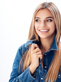 Attractive woman in jean jacket smiling