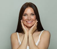 woman touching their face