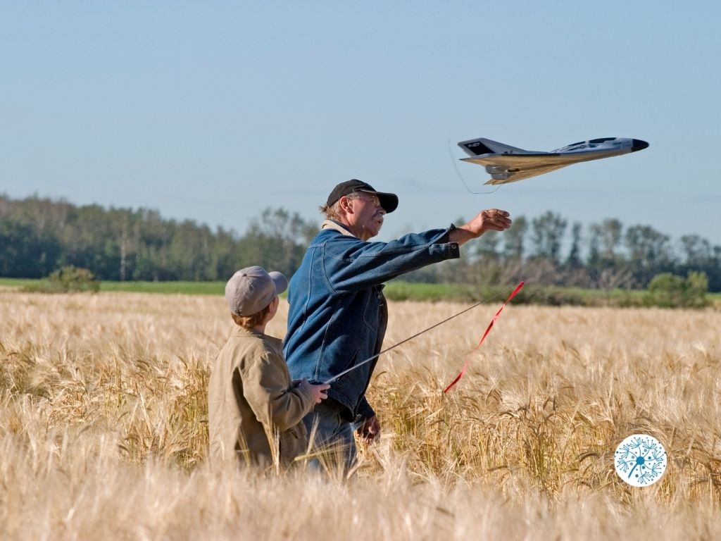 Kid and father playing RC plane