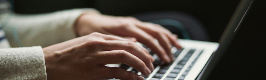 Typing on a laptop
