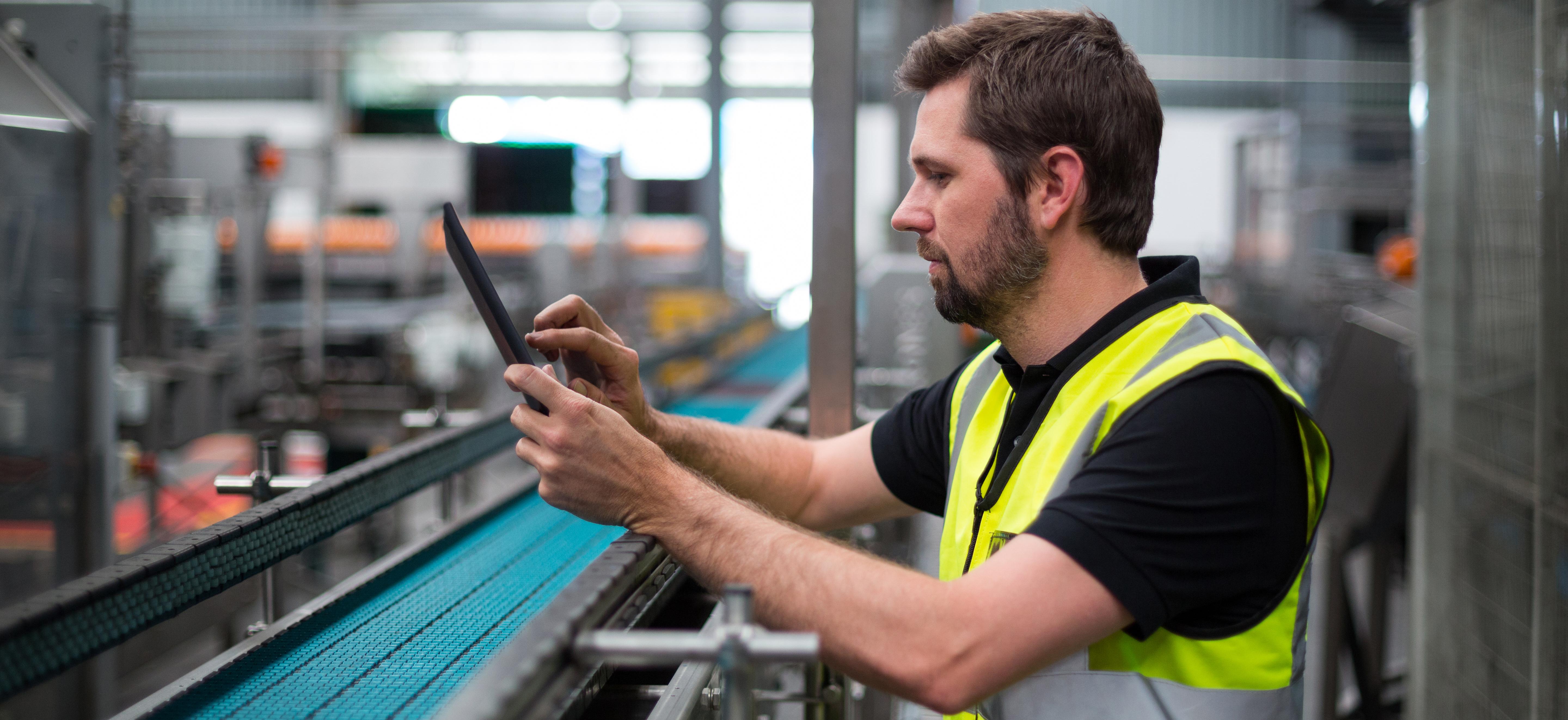 https://www.datocms-assets.com/38028/1614980543-factory-worker-using-a-digital-tablet-in-factory-zs3w9hv-edited.png?auto=format
