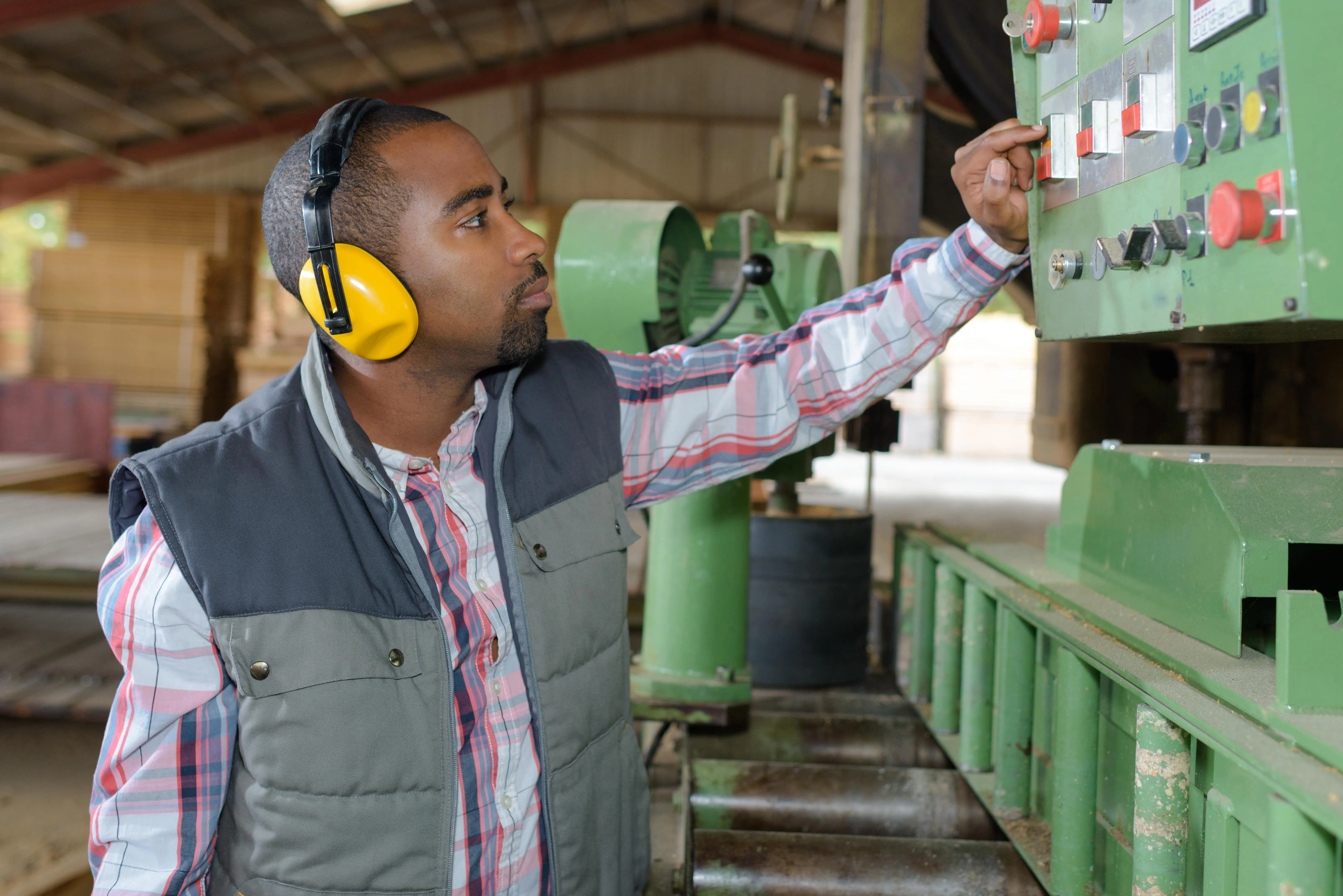 man-pressing-buttons-on-industrial-machine.jpg