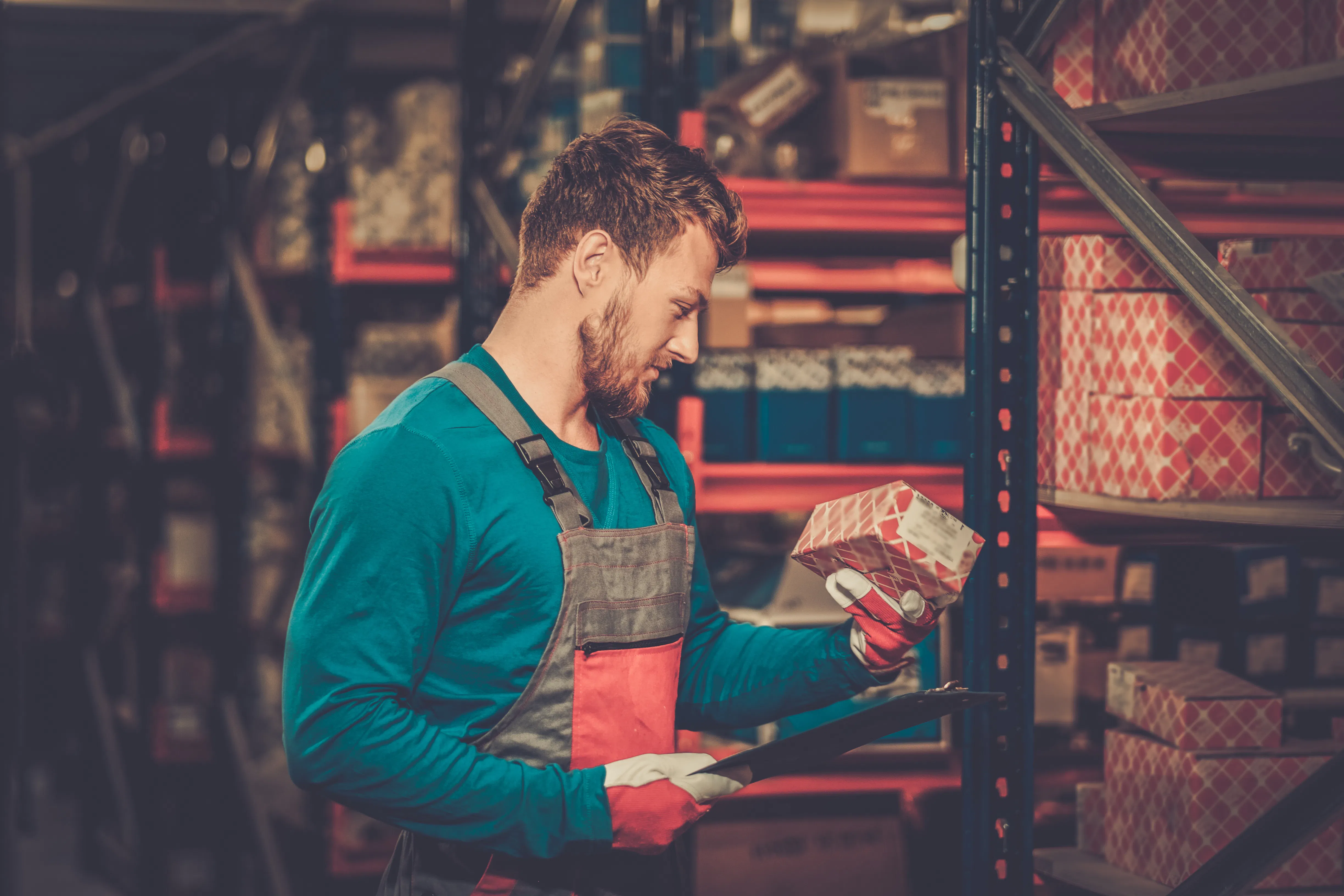 worker inspecting parts in storeroom