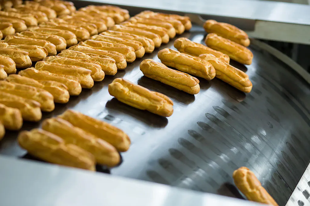 Yellow Eclair Shells on Conveyor