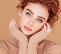 woman touching her face