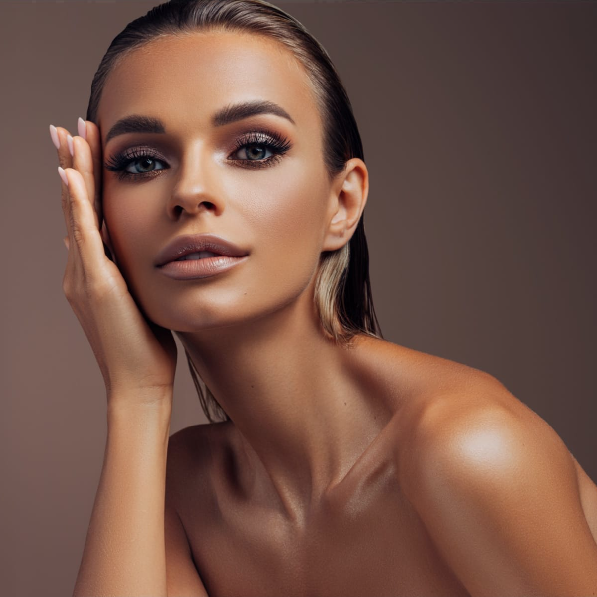 tan woman with hand on face