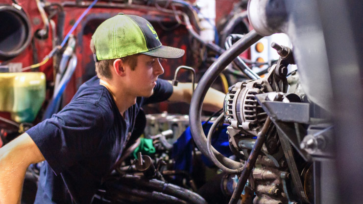 heavy duty technician working on engine