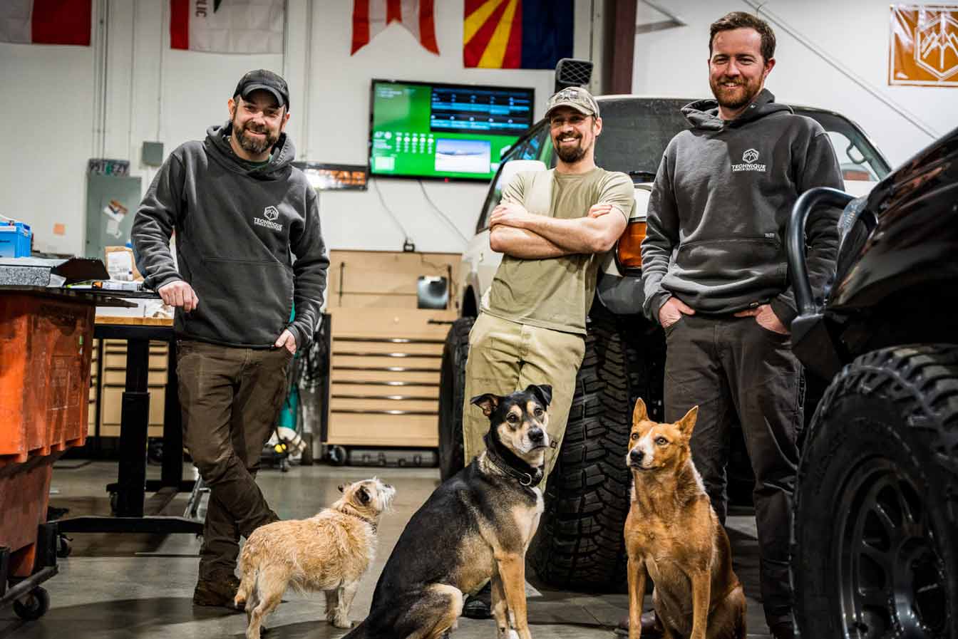 three dogs in an auto repair shop