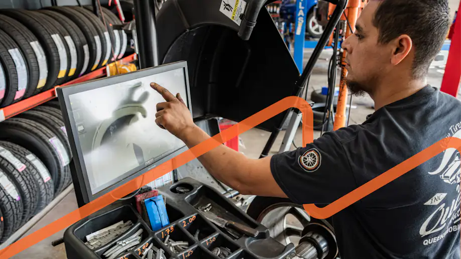 Man in a tire shop using a computer.