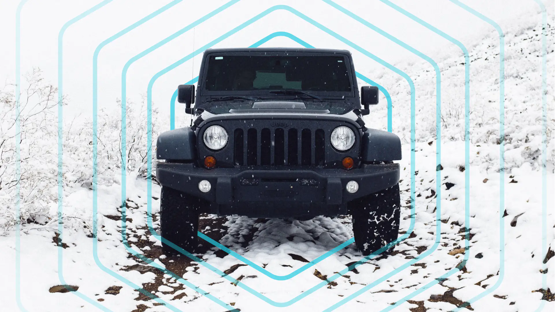 A black jeep on a snowy dirt road with a blue hexagon style target graphic