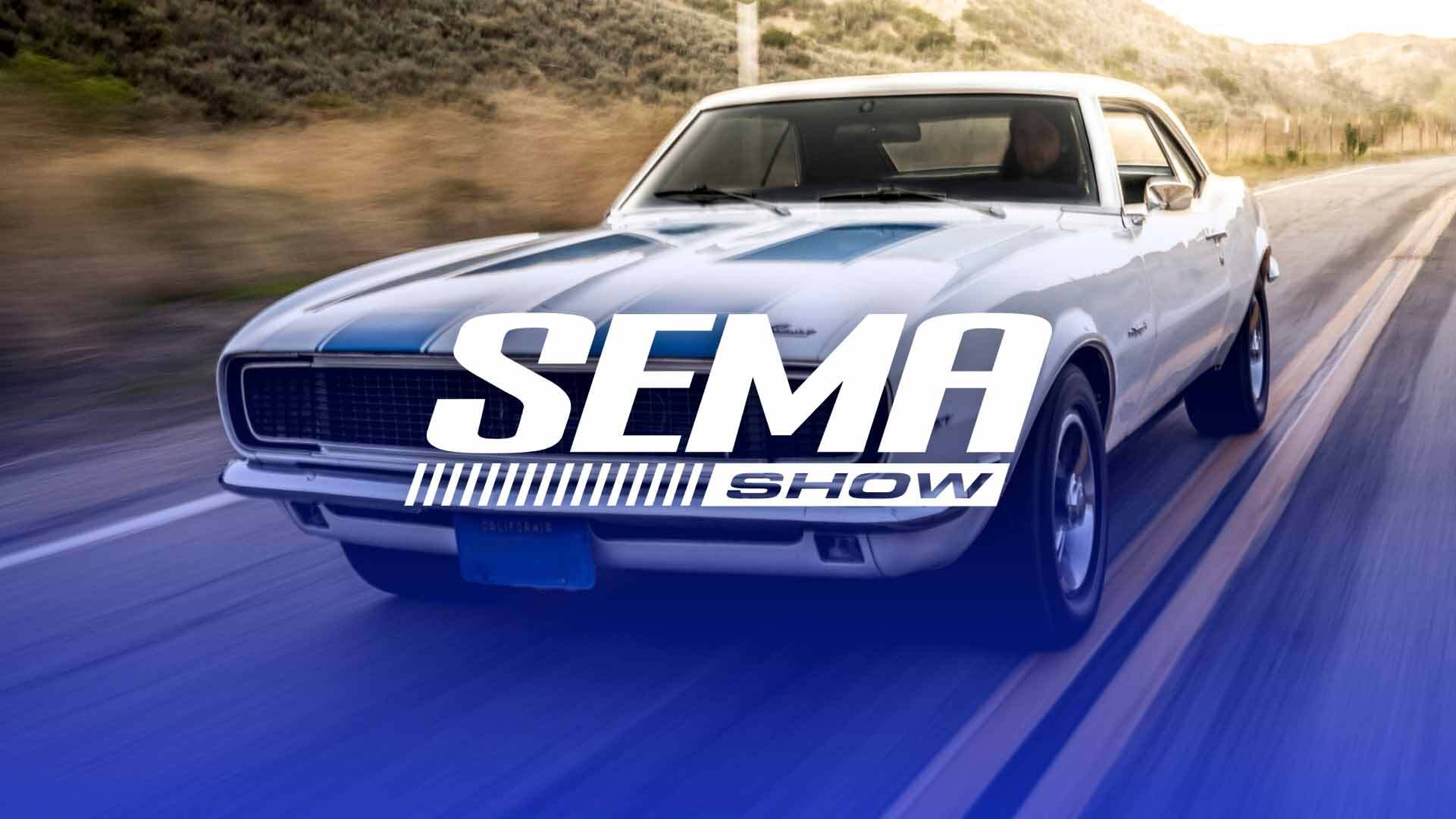 A camero driving on a road with the words SEMA SHOW overlayed