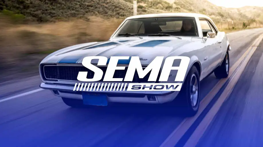 A camero driving on a road with the words SEMA SHOW overlayed