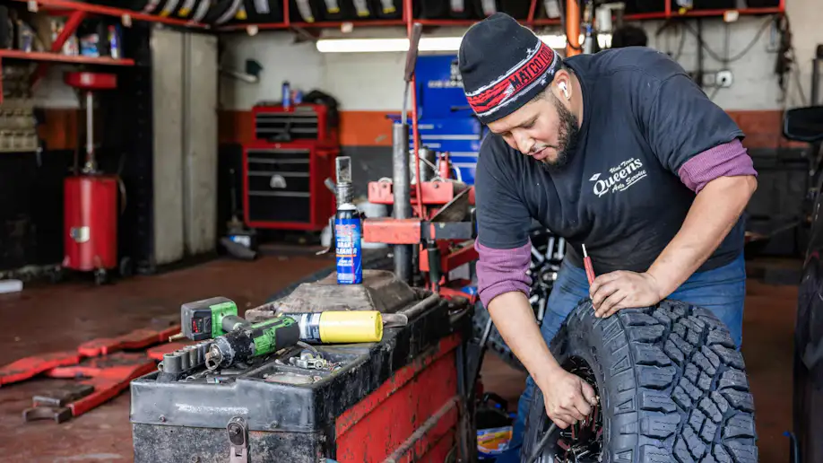 Technician fixing a tire.